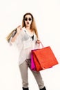 Woman with packages. Lady holds red and beige shopping bags.