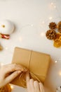 Woman packaging Christmas gift box. Royalty Free Stock Photo
