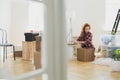 Woman packing books into carton boxes while moving out to a new Royalty Free Stock Photo