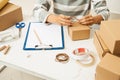 Woman packing cardboard boxes using tape dispenser Royalty Free Stock Photo