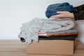 Woman packing clothes into cardboard donation box Royalty Free Stock Photo