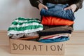 Woman packing clothes into cardboard donation box Royalty Free Stock Photo