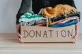 Woman packing clothes into cardboard donation box Royalty Free Stock Photo
