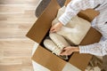 Woman packing clothes and shoes into cardboard box seasonal comfortable storage organize top view Royalty Free Stock Photo