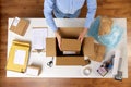 Woman packing fragile parcel boxes at post office