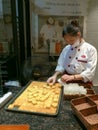 A woman packing freshly-baked pipeapple cake in a cake store in Xiamen city, China