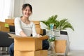 Woman packing her stuff in a cardboard boxes, preparing parcel for relocate Royalty Free Stock Photo