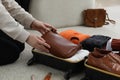 Woman packing suitcase for trip at home, closeup Royalty Free Stock Photo