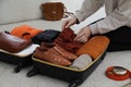Woman packing suitcase for trip at home, closeup Royalty Free Stock Photo