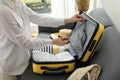 Woman packing suitcase for trip in living room, closeup Royalty Free Stock Photo