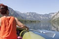 Woman paddle on calm mountain lake