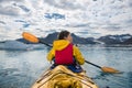 Woman paddle a canoe on an icy bay in Alaska exploring glaciers. Royalty Free Stock Photo