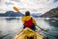 Woman paddle a canoe on an icy bay in Alaska exploring glaciers. Royalty Free Stock Photo