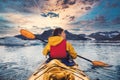Woman paddle a canoe on an icy bay in Alaska exploring glaciers. Royalty Free Stock Photo
