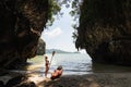 Woman with a paddle standing next to sea kayak at secluded beach in Krabi, Thailand Royalty Free Stock Photo