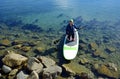 Woman on paddleboard in Dana Point Harbor, California. Royalty Free Stock Photo