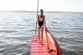 Woman with paddleboard on the pier outdoors Royalty Free Stock Photo