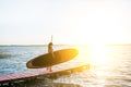 Woman with paddleboard on the pier outdoors Royalty Free Stock Photo