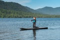 Woman paddleboarding on the mountain lake