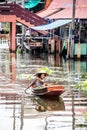 A woman paddles her boat