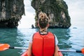 Woman paddles kayak in the lake with turquoise water. Royalty Free Stock Photo