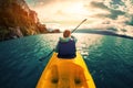 Woman paddles kayak in the lake with turquoise water Royalty Free Stock Photo