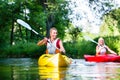 Woman paddling with canoe on forest river Royalty Free Stock Photo