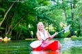 Woman paddling with canoe on forest river Royalty Free Stock Photo