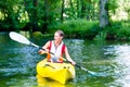 Woman paddling with canoe on forest river Royalty Free Stock Photo