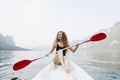 Woman paddling a canoe through a national park Royalty Free Stock Photo