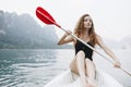 Woman paddling a canoe through a national park Royalty Free Stock Photo