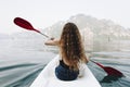 Woman paddling a canoe through a national park Royalty Free Stock Photo