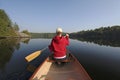 Woman Paddling a Canoe on a Northern Ontario Lake Royalty Free Stock Photo