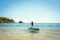 Woman paddling on a kayak on sea in clear water