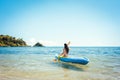 Woman paddling on a kayak on sea in clear water Royalty Free Stock Photo