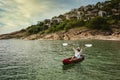 Woman paddling a kayak to exploring calm tropical bay with limestone mountains in Royalty Free Stock Photo