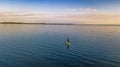 Woman paddling on SUP board on beautiful lake aerial drone view with reflections from above. Standing up paddle boarding adventure Royalty Free Stock Photo