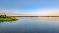 Woman paddling on SUP board on beautiful lake aerial drone view with reflections from above. Standing up paddle boarding adventure Royalty Free Stock Photo