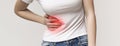 Woman in pain holding her stomach on right side Royalty Free Stock Photo