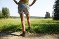 Woman with painful varicose veins on legs resting on a walk through nature