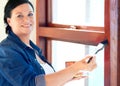 Woman, paint brush and portrait with varnish on window frame for home improvement and repair. Happy, smile and female Royalty Free Stock Photo