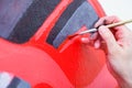 Woman paint little car Royalty Free Stock Photo