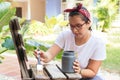 Woman With Paint Upcycling Chair At Home