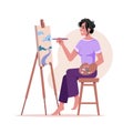 Woman painter artist draws on easel modern picture