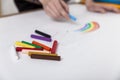 Woman painter is drawing a rainbow on a large sheet of paper Royalty Free Stock Photo