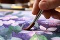 Woman painting beautiful flowers with watercolor