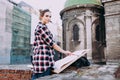 Woman is painting directly on the city street against the background of old architecture. Young painter artist in work Royalty Free Stock Photo