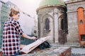 Woman is painting directly on the city street against the background of old architecture. Young painter artist in work Royalty Free Stock Photo