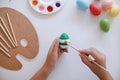 Woman painting Easter eggs at home. family preparing for Easter. Royalty Free Stock Photo