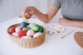 Woman painting Easter eggs at home. family preparing for Easter. Royalty Free Stock Photo
